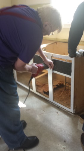 My dad using a sawzall on one of the cabinets