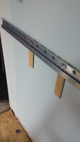 One lower rail, with shims because the wall is not flat